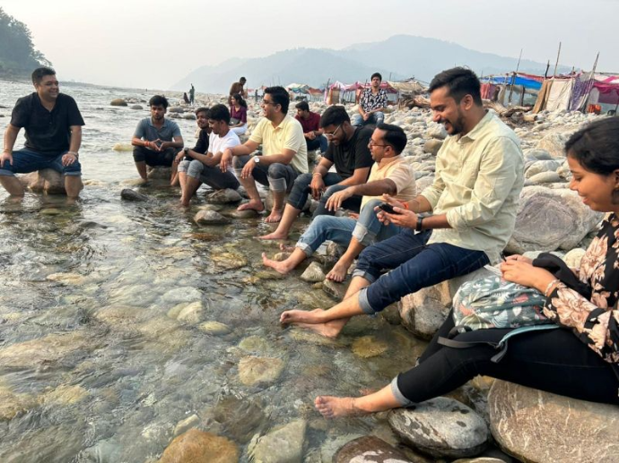 i8CLOUD team enjoying a serene riverside moment at Jim Corbett – blending relaxation and nature during a memorable team getaway. Would you like me to group t